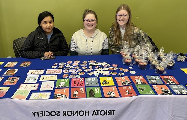 Triota members at a table